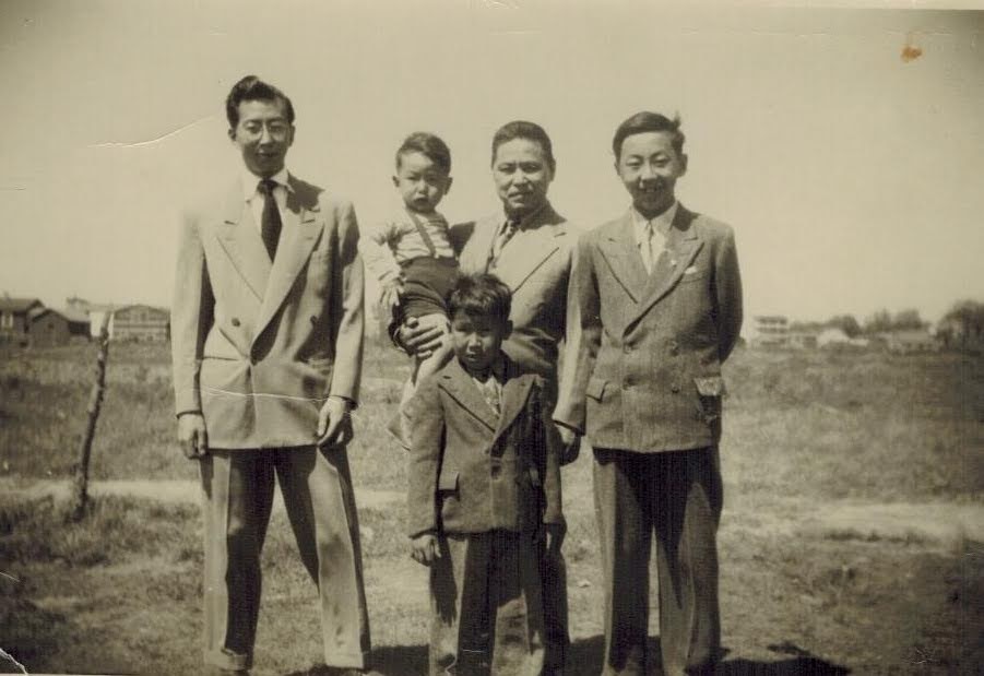 Takeda boys in field outside of house